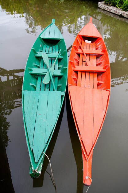 green and red boat on the lake