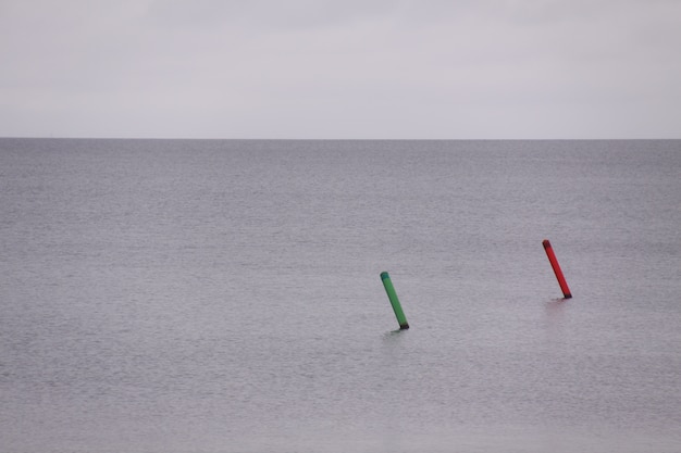 Green and red buoy in the sea