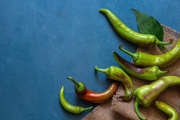 Green and red peppers on a blue 