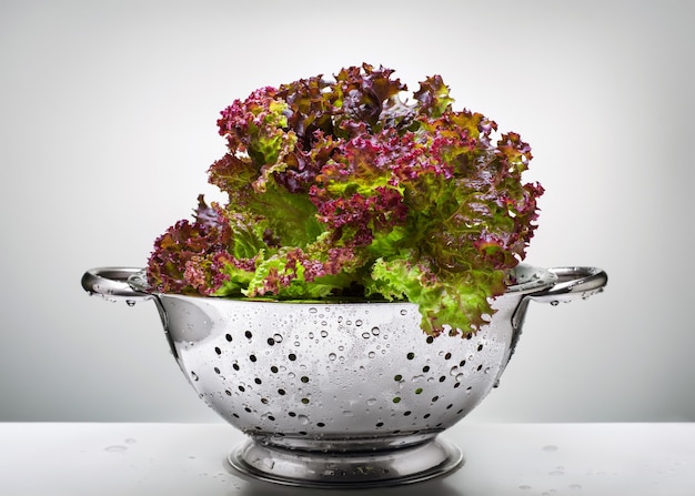 Green and red salad in a colander