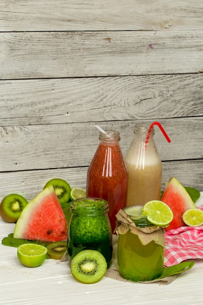 green and red smoothies in a jar with lime, kiwi