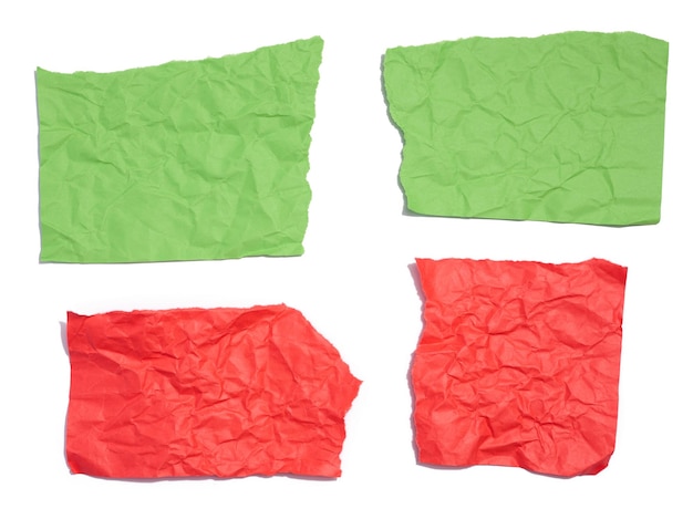 Green and red torn pieces of paper on a white isolated background