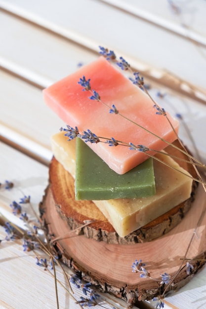 Green, red and yellow soaps with a lavender flowers in a romantic setting.