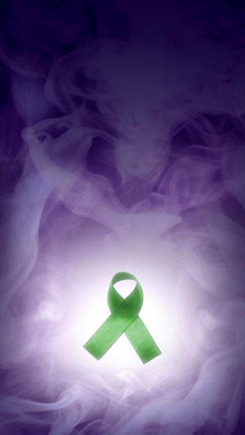 Green ribbon with smoked background World mental health day concept