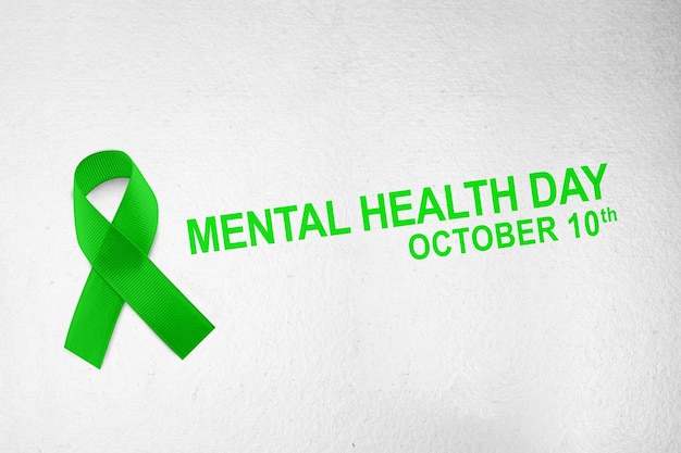 Photo green ribbon with white wall background world mental health day concept