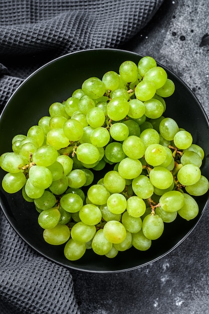 Green ripe grapes in a plate, fruits of autumn.  