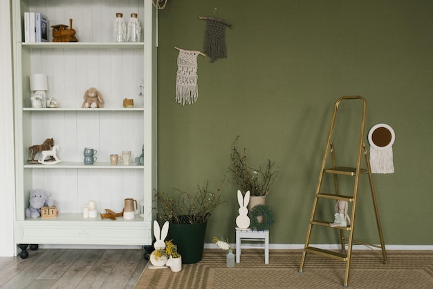 Green room with a white bookshelf and a staircase decorated for Easter