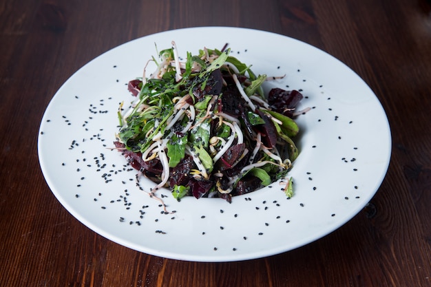 Green salad with beetroot on a round plate