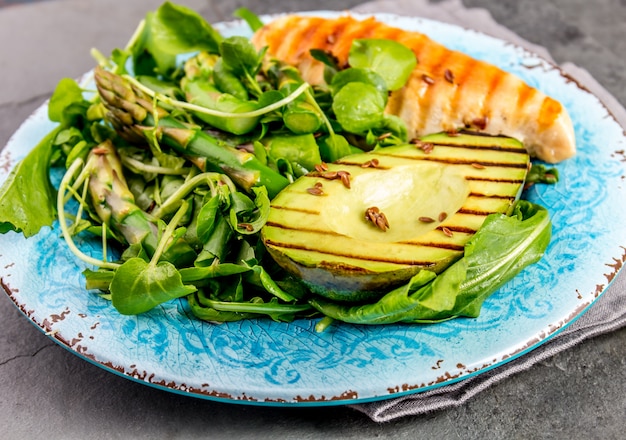 Green salad with grilled avicado and grilled chicken