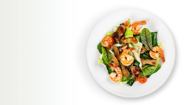 Green salad with shrimps on background