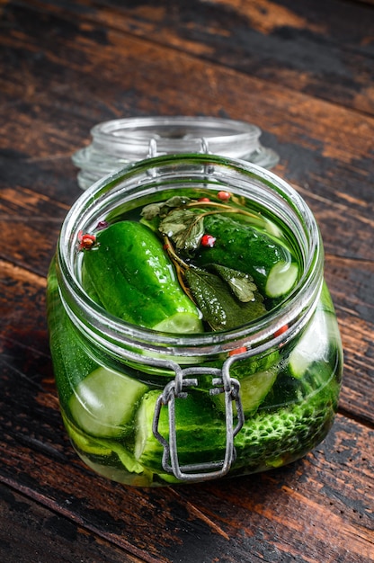 Green salted cucumbers in a glass jar