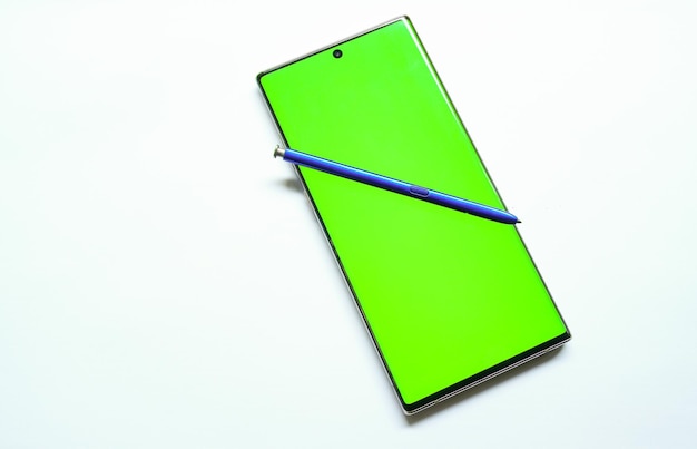 A green samsung galaxy notepad sits on a white surface.