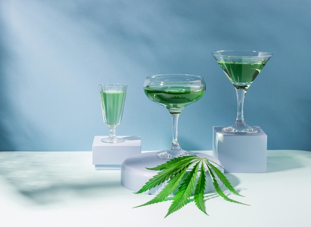 Green SBD hemp drink on creative modern podium blue hard shadows background cannabis cocktail