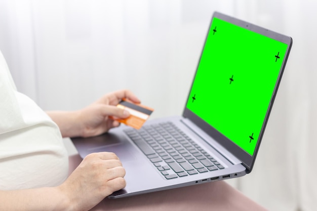 Green screen design concept Side view of woman hands holding credit card