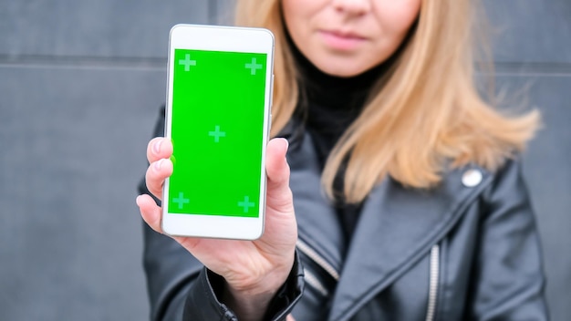 green screen mobile in women hand