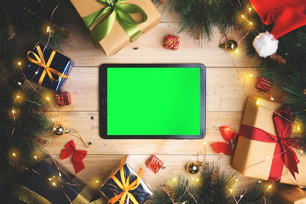 Photo green screen tablet device between christmas decoration. top view