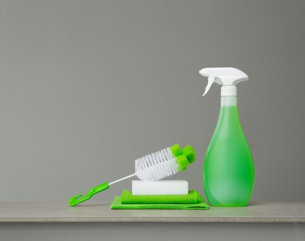 Green set of cleaning products and tools for spring cleaning.