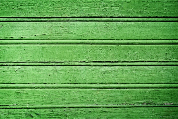 Green shabby cracked wooden background