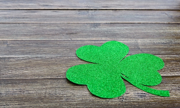 Green shamrock on a wooden background. St.Patrick 's Day background