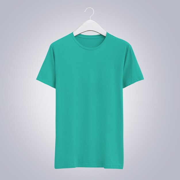 Photo a green shirt hanging on a hanger with a white shirt hanging on it