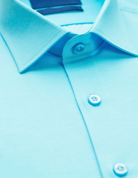 Green shirt with a focus on the collar and button, close-up