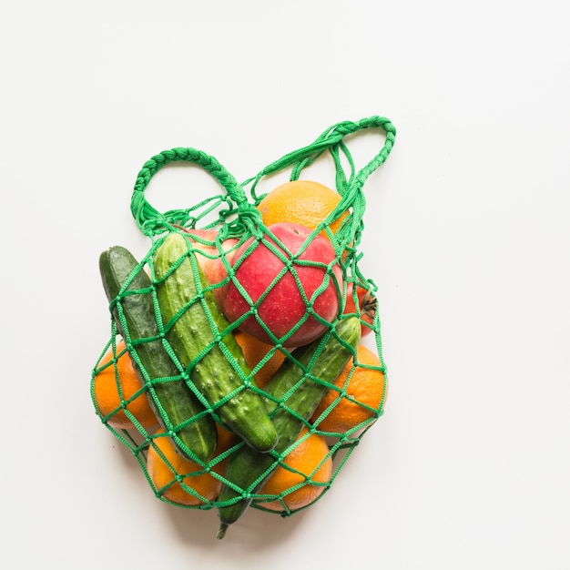 Green shopping textile bag with produce.