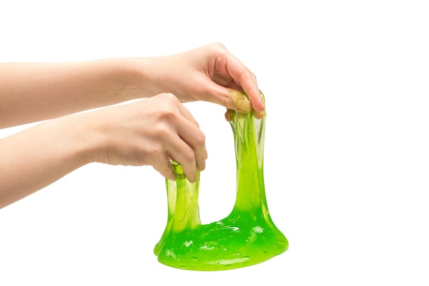 Green slime toy in woman hand isolated on white.