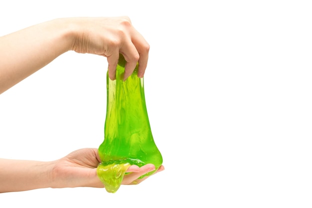 Green slime toy in woman hand isolated on white.