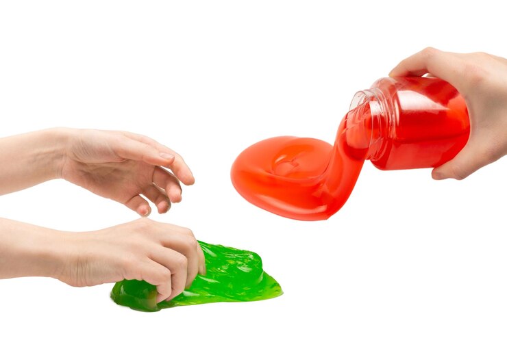 Photo green slime toy in woman hand isolated on white