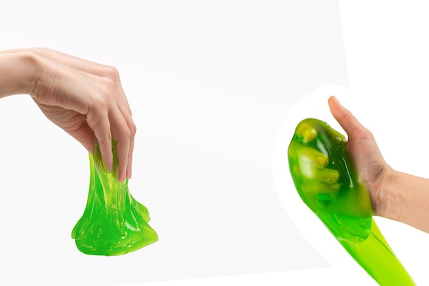 Green slime toy in woman hand isolated on white