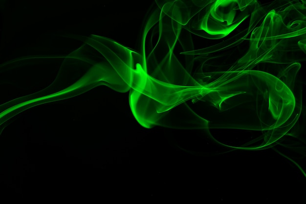 Green smoke abstract on black background, darkness concept