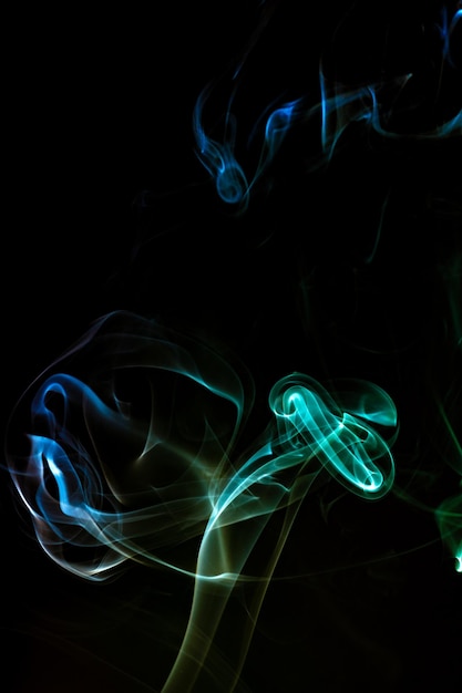 Green smoke against a black background