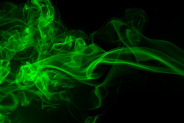 Green smoke on black background, darkness concept