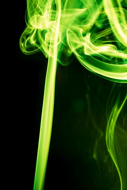 Green smoke on black background.