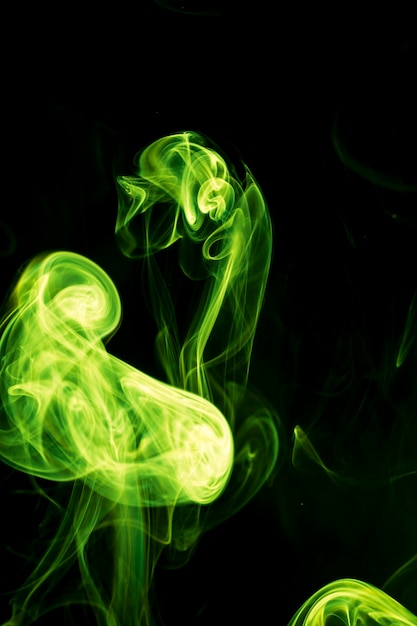 Green smoke on black background.