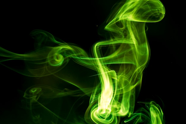 Green smoke on black background.