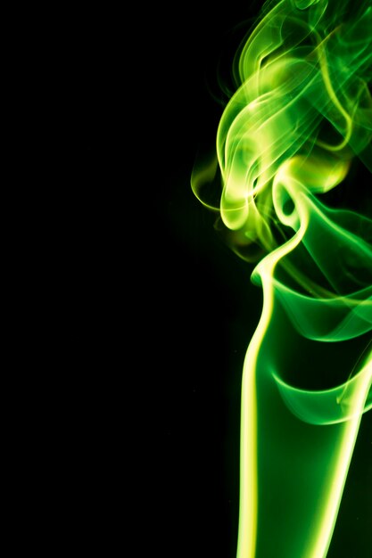 Green smoke on black background.