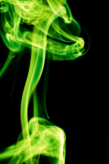 Green smoke on black background.