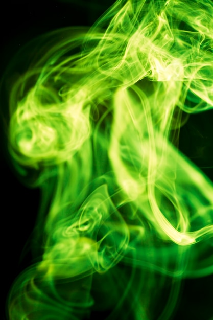 Green smoke on black background.