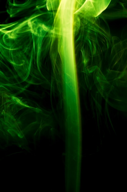 Green smoke on black background.