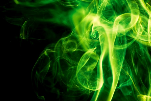 Green smoke on black background.