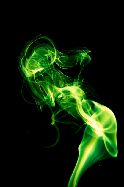 Green smoke on black background.