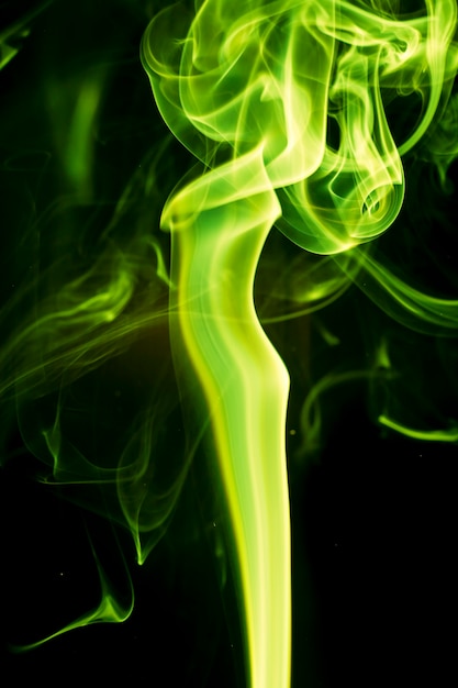 Green smoke on black background.