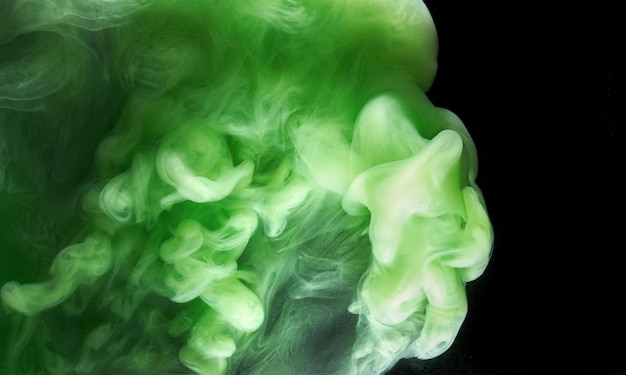 Green smoke on black ink background, colorful fog, abstract swirling emerald ocean sea, acrylic paint pigment underwater