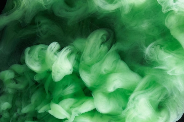 Green smoke on black ink background, colorful fog, abstract swirling emerald ocean sea, acrylic paint pigment underwater