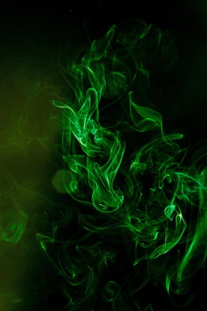 Green smoke motion on black background.