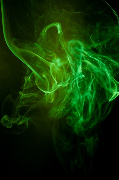 Green smoke motion on black background.