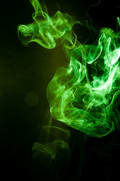 Green smoke motion on black background.