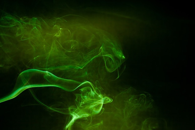 Green smoke motion on black background.