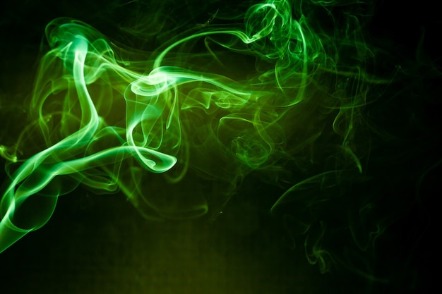 Green smoke motion on black background.